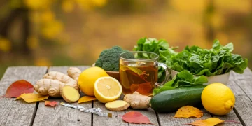 Autumn detox ingredients with herbal tea on a rustic table